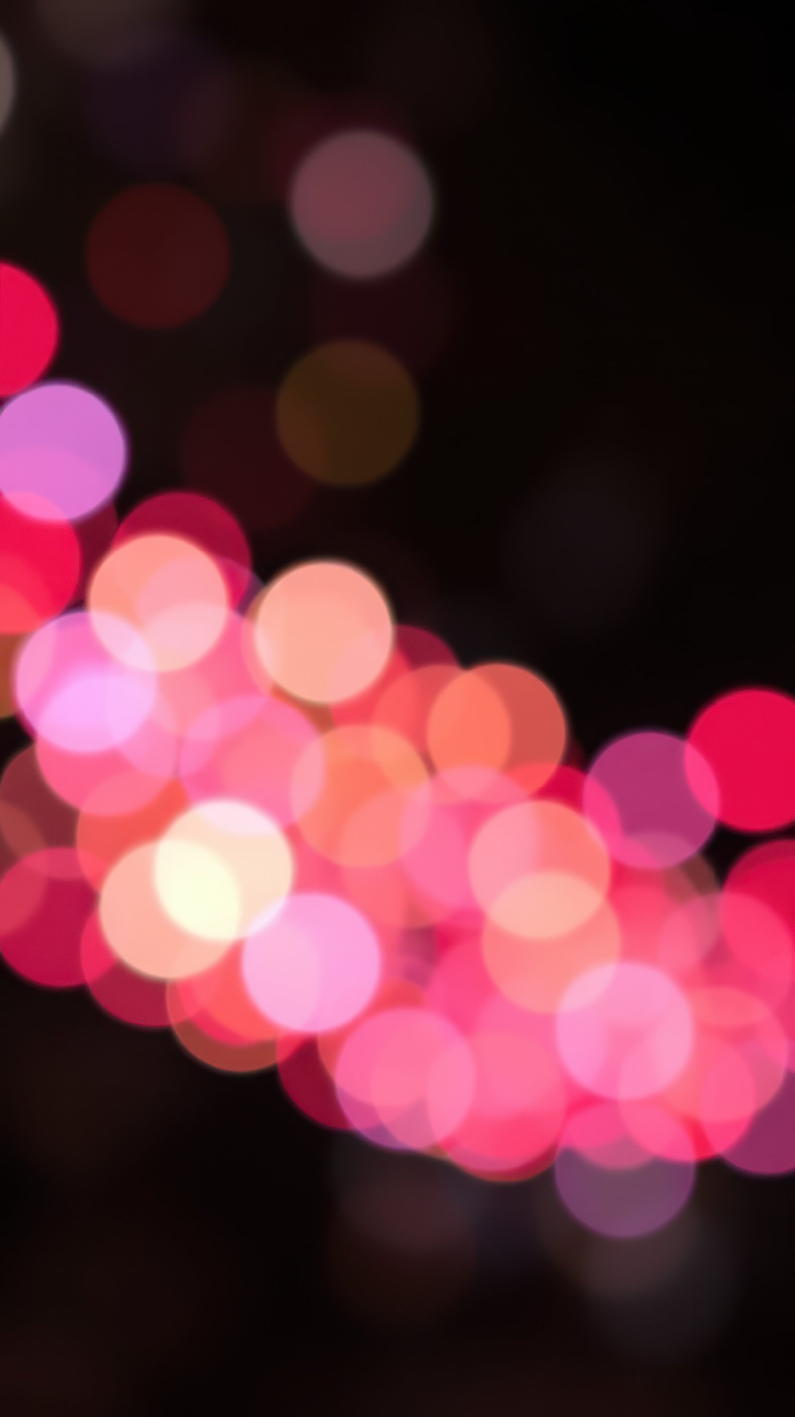 Colorful bokeh lights create a vibrant atmosphere during an evening celebration